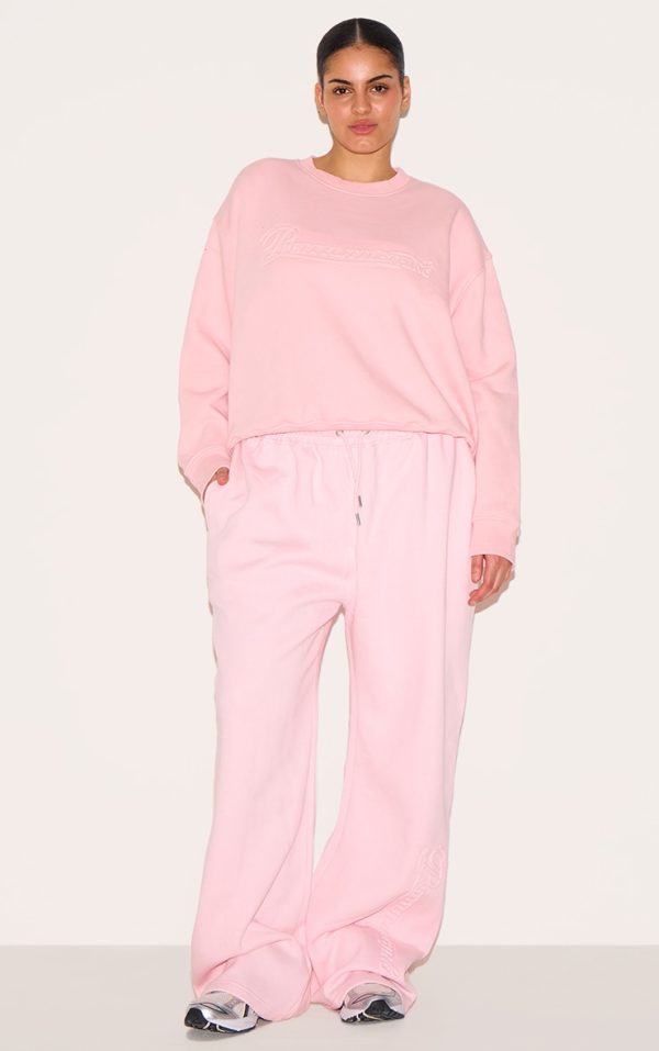 PRETTYLITTLETHING Plus Baby Pink Embossed Graphic Straight Leg Sweatpants